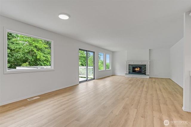13428 SE 302nd Pl, Auburn, WA 98092 - unfurnished living room with light wood-style floors and a fireplace