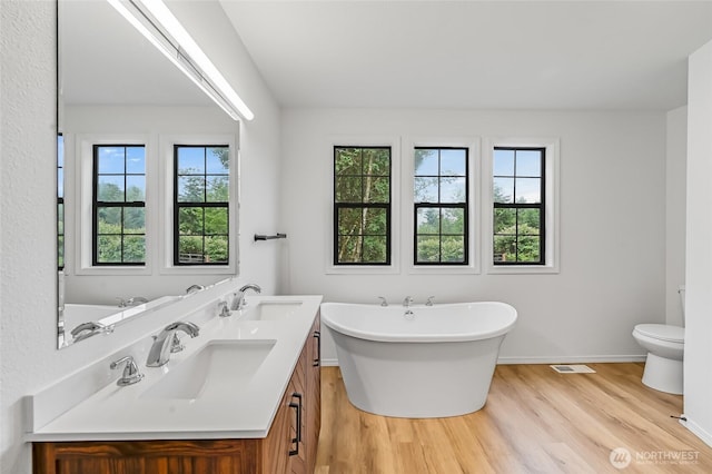 13428 SE 302nd Pl, Auburn, WA 98092 - bathroom with wood finished floors, double vanity, and a freestanding bath