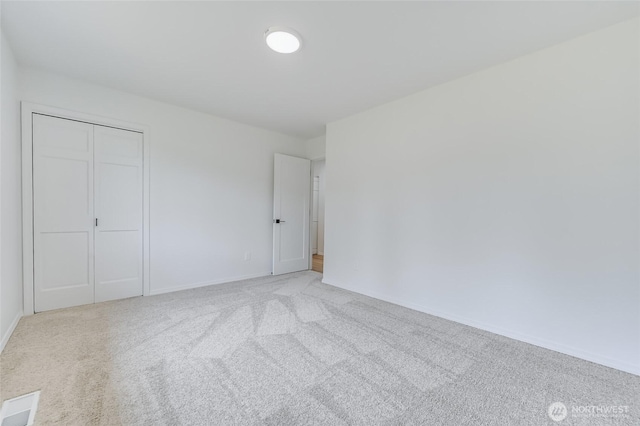 13428 SE 302nd Pl, Auburn, WA 98092 - unfurnished bedroom featuring light carpet and a closet