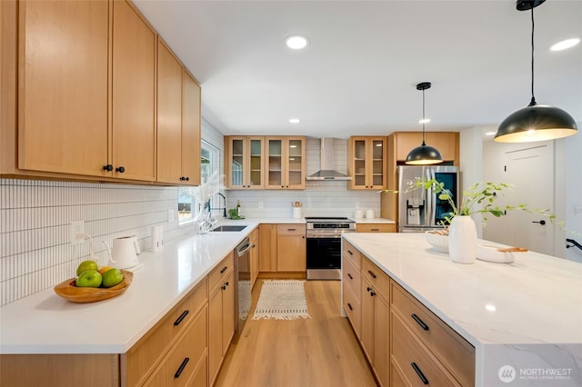 20126 81st Ave W, Edmonds, WA 98026 - kitchen with stainless steel appliances, wall chimney range hood, light wood-style flooring, tasteful backsplash, and a center island