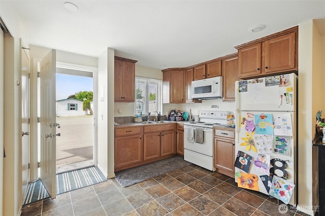 108 Baker St Unit 1-4, Everson, WA 98247 - kitchen featuring white appliances, brown cabinets, dark stone finish floors, and light countertops