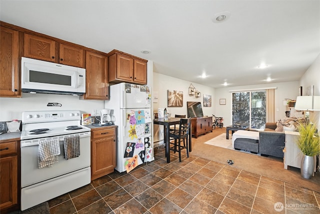 108 Baker St Unit 1-4, Everson, WA 98247 - kitchen featuring white appliances, open floor plan, brown cabinetry, recessed lighting, and dark stone finish floors