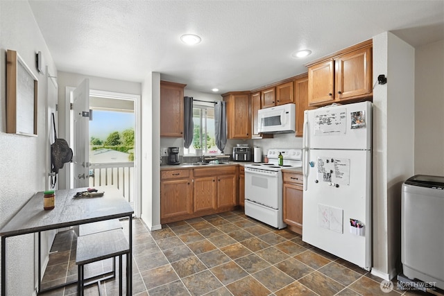 108 Baker St Unit 1-4, Everson, WA 98247 - kitchen featuring white appliances, recessed lighting, brown cabinets, dark stone finish flooring, and light countertops