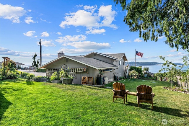 809 W Rocky Point Dr, Camano Island, WA 98282 - rear view of property with a yard, board and batten siding, a water view, a chimney, and a shingled roof