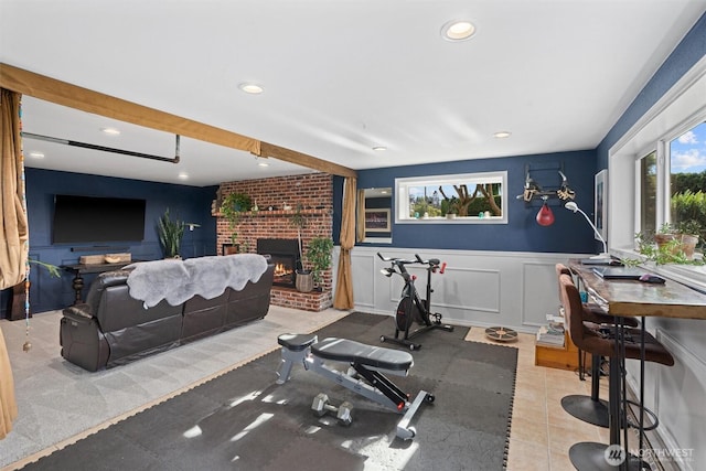 809 W Rocky Point Dr, Camano Island, WA 98282 - exercise room featuring plenty of natural light, a brick fireplace, wainscoting, recessed lighting, and a decorative wall