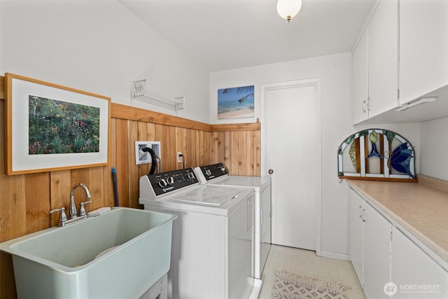 809 W Rocky Point Dr, Camano Island, WA 98282 - laundry area with cabinet space, washer and dryer, wooden walls, and a wainscoted wall