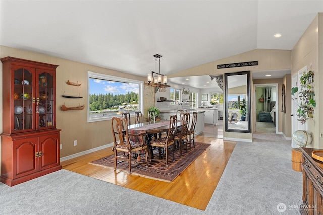 809 W Rocky Point Dr, Camano Island, WA 98282 - dining area with light wood-style flooring, a chandelier, lofted ceiling, and light carpet