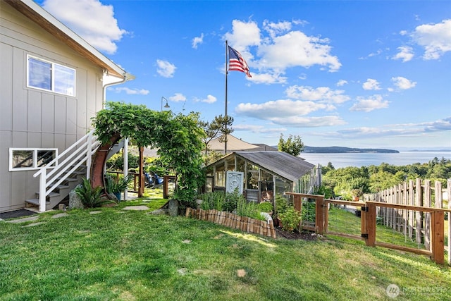 809 W Rocky Point Dr, Camano Island, WA 98282 - view of yard with stairs, a water view, an outbuilding, and an exterior structure