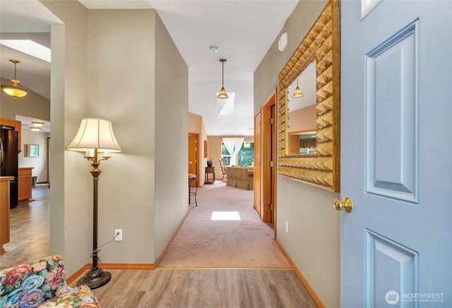 5626 Thane Ln SE, Port Orchard, WA 98367 - corridor featuring light wood finished floors, light colored carpet, and a towering ceiling