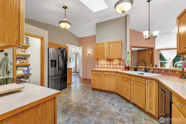 5626 Thane Ln SE, Port Orchard, WA 98367 - kitchen with stainless steel fridge with ice dispenser, a skylight, decorative backsplash, dishwasher, and light countertops