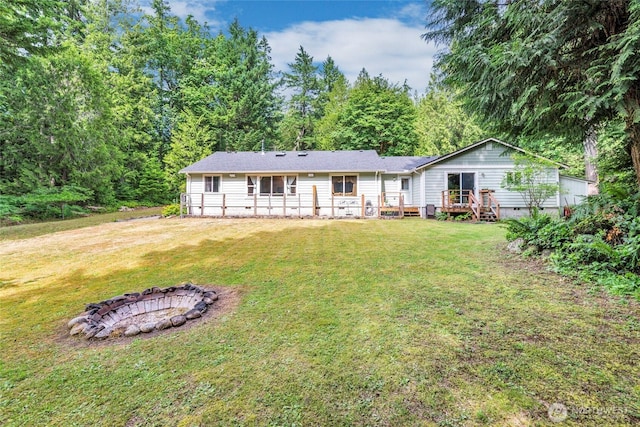 5626 Thane Ln SE, Port Orchard, WA 98367 - back of house with an outdoor fire pit, a lawn, crawl space, and a wooden deck