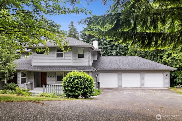 6345 Agnes Rd NE, Tacoma, WA 98422 - view of front facade with an attached garage, a chimney, asphalt driveway, a porch, and a shingled roof