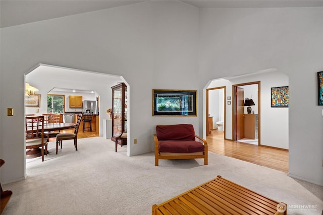 6345 Agnes Rd NE, Tacoma, WA 98422 - living area featuring light carpet, arched walkways, and high vaulted ceiling