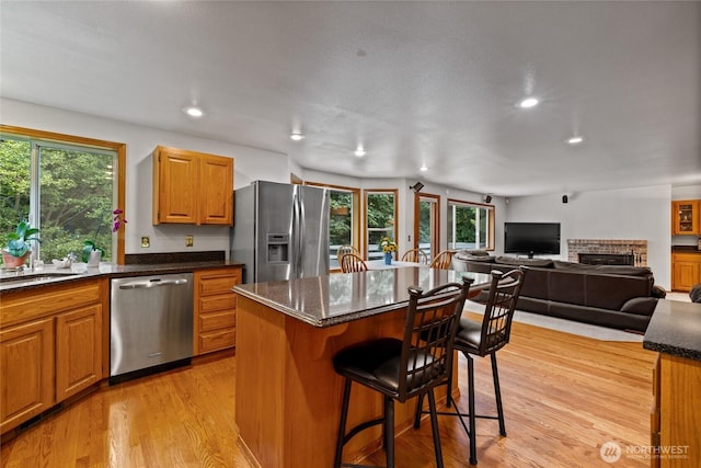 6345 Agnes Rd NE, Tacoma, WA 98422 - kitchen with stainless steel appliances, plenty of natural light, a kitchen breakfast bar, light wood-style floors, and recessed lighting