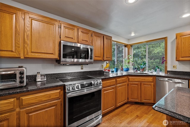 6345 Agnes Rd NE, Tacoma, WA 98422 - kitchen with stainless steel appliances, light wood-type flooring, recessed lighting, and brown cabinets