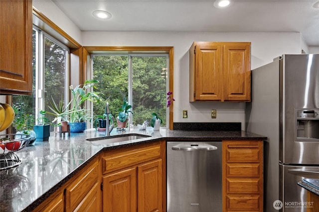 6345 Agnes Rd NE, Tacoma, WA 98422 - kitchen with appliances with stainless steel finishes, brown cabinetry, dark stone counters, and recessed lighting