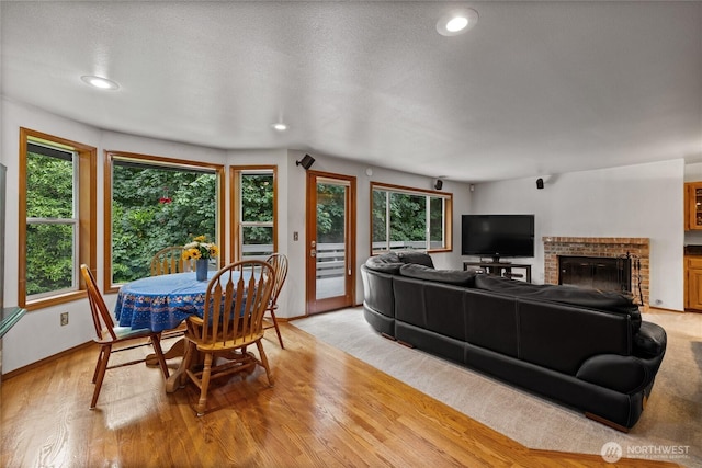 6345 Agnes Rd NE, Tacoma, WA 98422 - living room with light wood-type flooring, recessed lighting, and a brick fireplace
