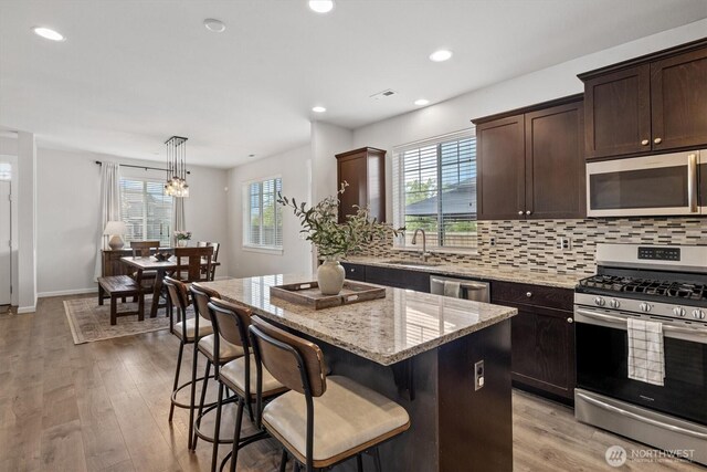 3119 13th Avenue Ct NW, Puyallup, WA 98371 - kitchen featuring stainless steel appliances, a center island, plenty of natural light, backsplash, and recessed lighting