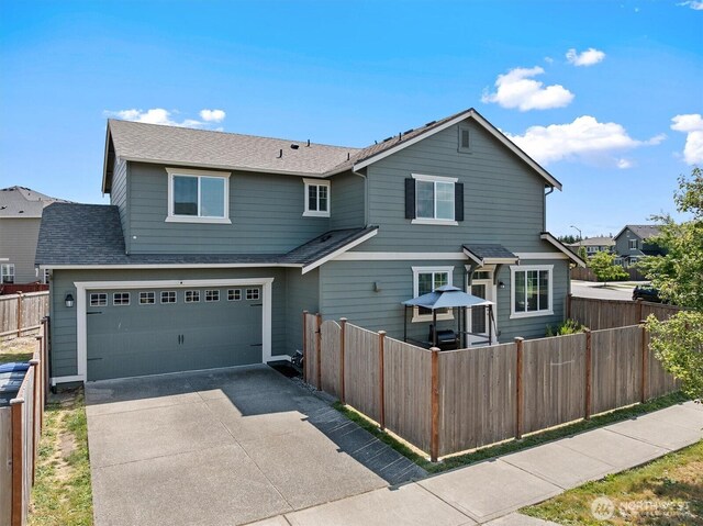 3119 13th Avenue Ct NW, Puyallup, WA 98371 - traditional-style home with concrete driveway, a garage, and a shingled roof