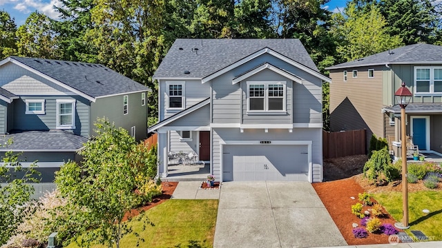 1610 NE Calavista St, Poulsbo, WA 98370 - view of front facade with an attached garage, concrete driveway, and a shingled roof