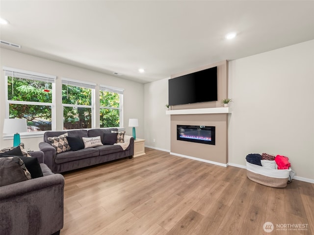 1610 NE Calavista St, Poulsbo, WA 98370 - living room with light wood finished floors, a glass covered fireplace, and recessed lighting