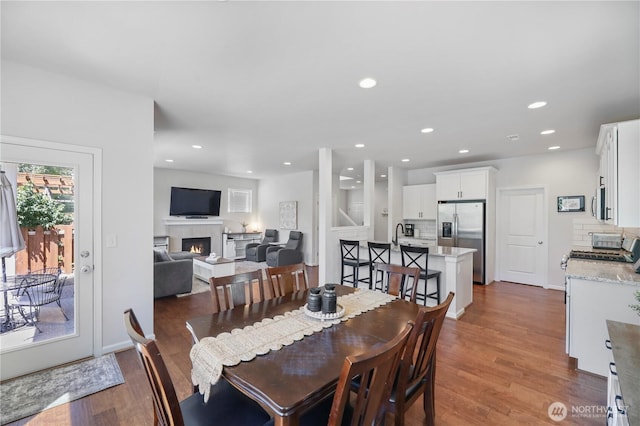 4508 29th Ave SE, Everett, WA 98203 - dining space with wood finished floors, a fireplace, and recessed lighting
