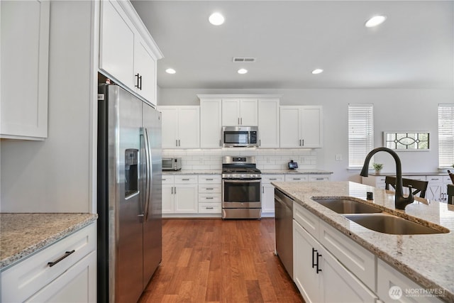 4508 29th Ave SE, Everett, WA 98203 - kitchen featuring appliances with stainless steel finishes, white cabinets, tasteful backsplash, dark wood-style floors, and recessed lighting