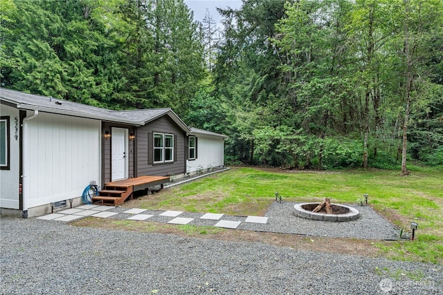 5279 SE Lars Hansen Rd, Port Orchard, WA 98367 - view of green lawn with an outdoor fire pit