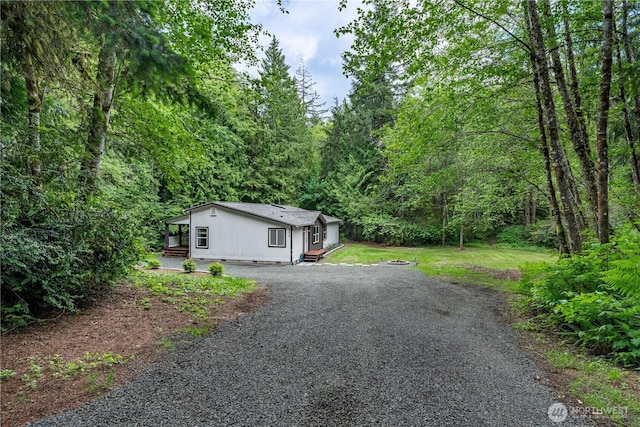 5279 SE Lars Hansen Rd, Port Orchard, WA 98367 - view of front of property with driveway and a view of trees