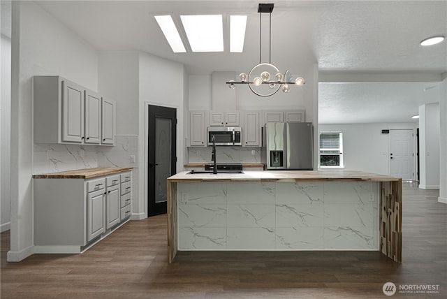 5279 SE Lars Hansen Rd, Port Orchard, WA 98367 - kitchen with appliances with stainless steel finishes, wood counters, decorative backsplash, and dark wood-type flooring