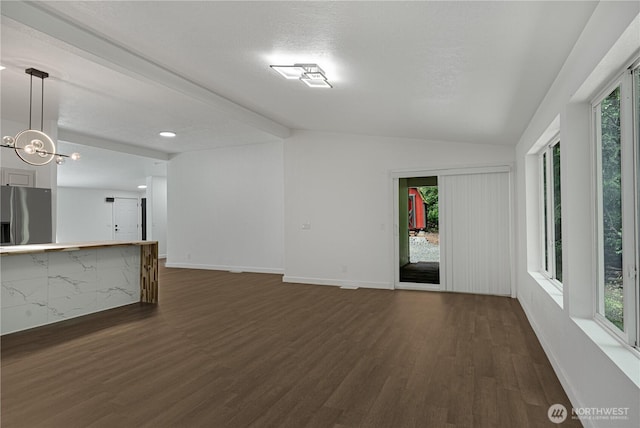 5279 SE Lars Hansen Rd, Port Orchard, WA 98367 - unfurnished living room featuring dark wood-type flooring, healthy amount of natural light, and vaulted ceiling