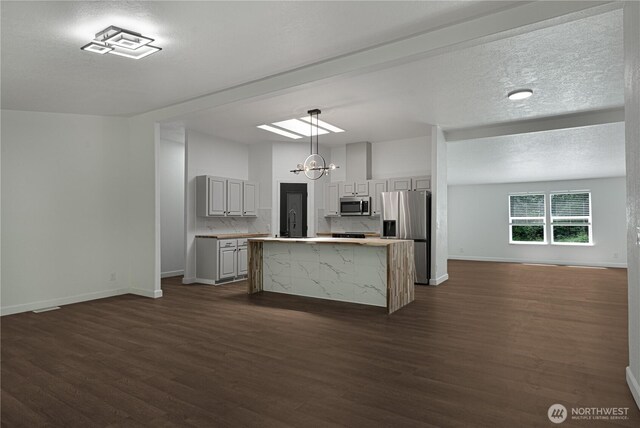 5279 SE Lars Hansen Rd, Port Orchard, WA 98367 - kitchen featuring stainless steel appliances, open floor plan, dark wood finished floors, light countertops, and gray cabinetry