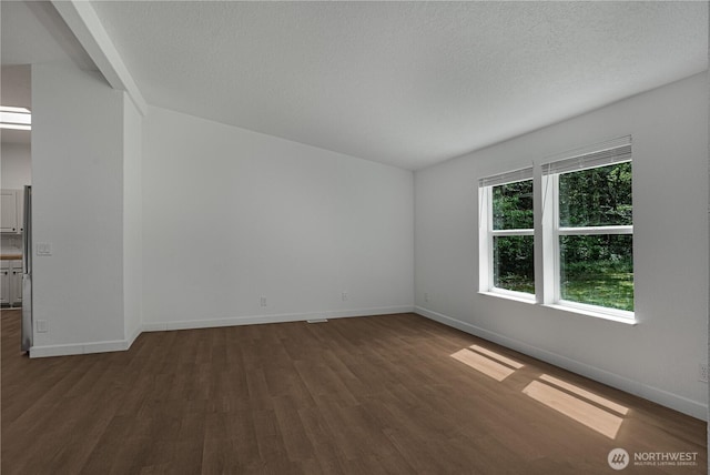 5279 SE Lars Hansen Rd, Port Orchard, WA 98367 - empty room with dark wood-style floors and a textured ceiling