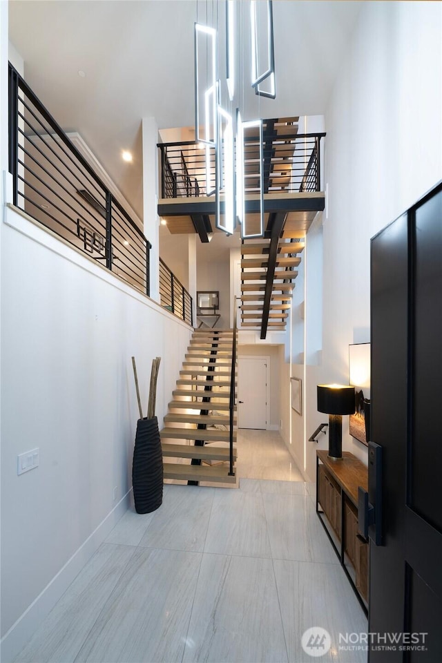 11888 SE 5th St, Bellevue, WA 98005 - staircase featuring a high ceiling and baseboards