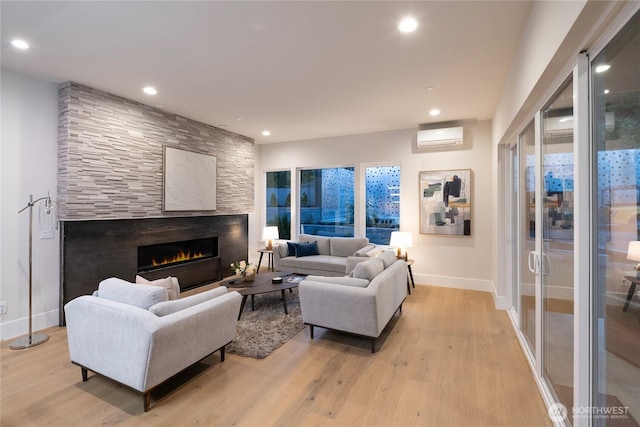 11888 SE 5th St, Bellevue, WA 98005 - living area with an AC wall unit, light wood-style flooring, a fireplace, and recessed lighting