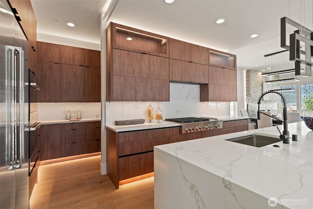 11888 SE 5th St, Bellevue, WA 98005 - kitchen with modern cabinets, appliances with stainless steel finishes, light stone counters, light wood-type flooring, and recessed lighting