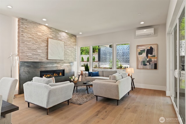 11888 SE 5th St, Bellevue, WA 98005 - living room featuring a wall mounted AC, a fireplace, light wood-style floors, and recessed lighting