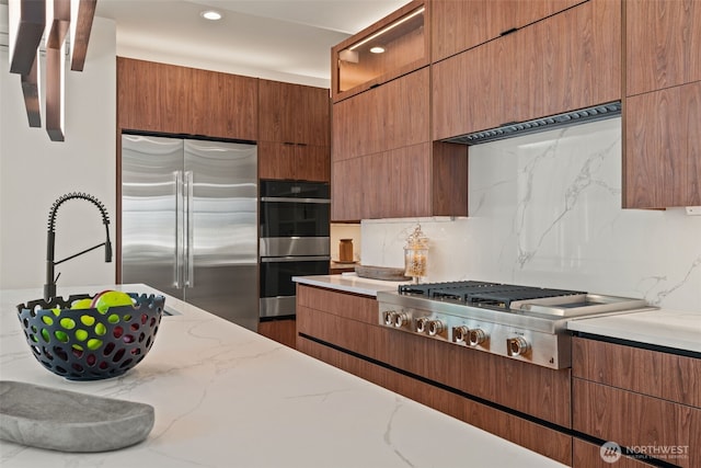 11888 SE 5th St, Bellevue, WA 98005 - kitchen with stainless steel appliances, light stone counters, modern cabinets, and recessed lighting