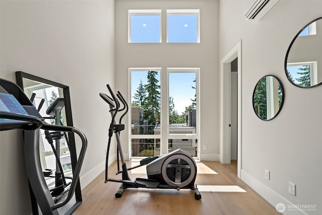 11888 SE 5th St, Bellevue, WA 98005 - workout area featuring a high ceiling, wood finished floors, and an AC wall unit