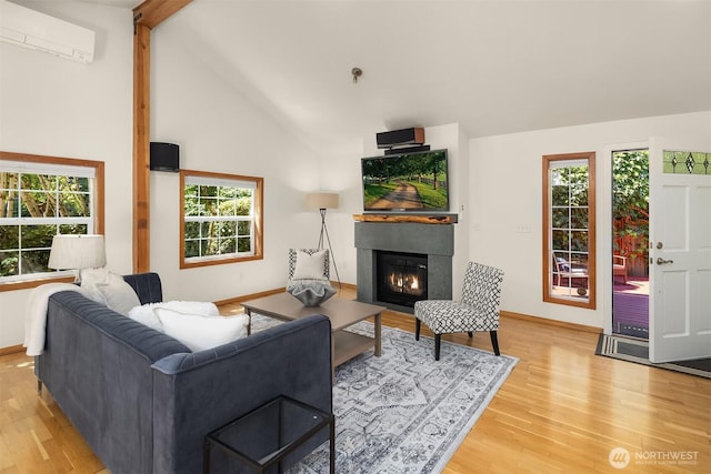 537 30th Ave E, Seattle, WA 98112 - living room with a wall mounted air conditioner, light wood-style flooring, and a fireplace with flush hearth