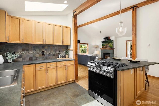537 30th Ave E, Seattle, WA 98112 - kitchen featuring gas stove, tasteful backsplash, open floor plan, dark countertops, and a skylight