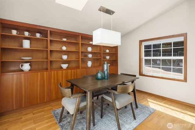 537 30th Ave E, Seattle, WA 98112 - dining room with lofted ceiling, light wood-style flooring, and a skylight