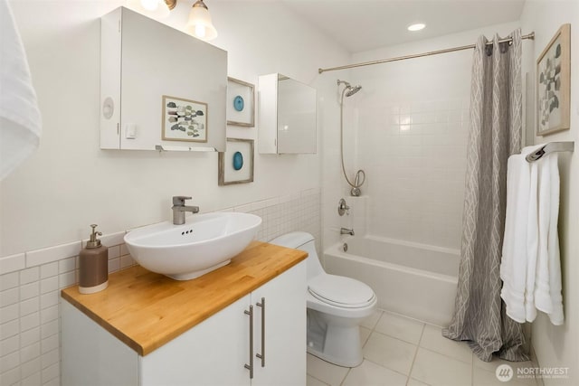 537 30th Ave E, Seattle, WA 98112 - bathroom featuring tile walls, tile patterned floors, shower / bath combo with shower curtain, vanity, and a wainscoted wall
