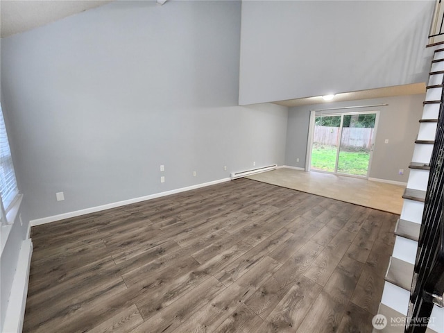 3624 159th Street Ct E, Tacoma, WA 98446 - spare room featuring a baseboard heating unit and wood finished floors
