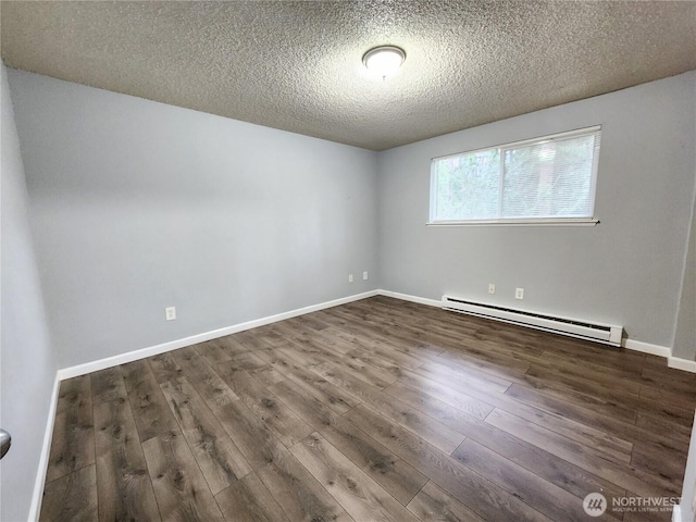 3624 159th Street Ct E, Tacoma, WA 98446 - unfurnished room with a baseboard heating unit, wood finished floors, and a textured ceiling