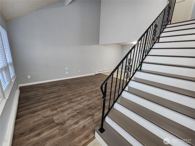 3624 159th Street Ct E, Tacoma, WA 98446 - stairway with wood finished floors, vaulted ceiling, and a baseboard heating unit