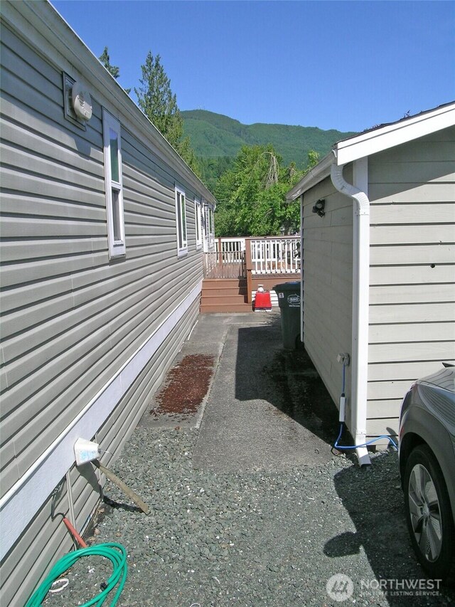 921 Autumn Ln Unit 254, Bellingham, WA 98229 - view of property exterior with a deck with mountain view