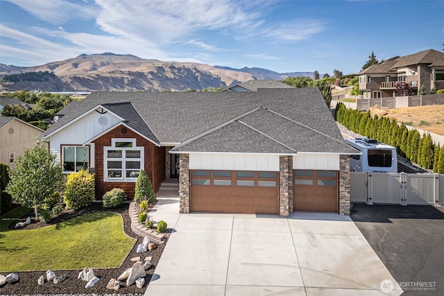 453 Spruce Ct NW, East Wenatchee, WA 98802 - view of front facade with a gate, a shingled roof, an attached garage, driveway, and board and batten siding