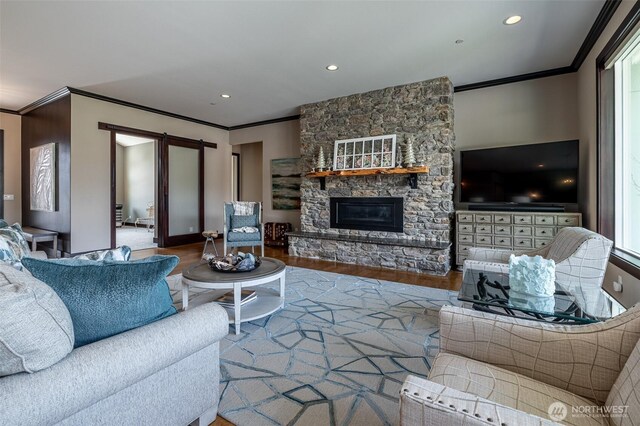 453 Spruce Ct NW, East Wenatchee, WA 98802 - living room with crown molding, wood finished floors, a stone fireplace, and recessed lighting