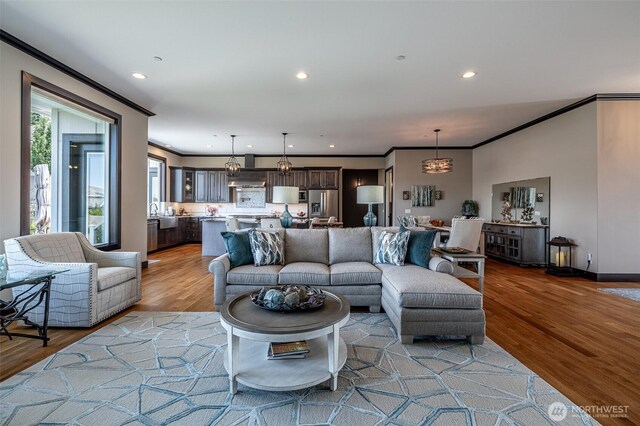 453 Spruce Ct NW, East Wenatchee, WA 98802 - living room featuring wood finished floors, ornamental molding, and recessed lighting